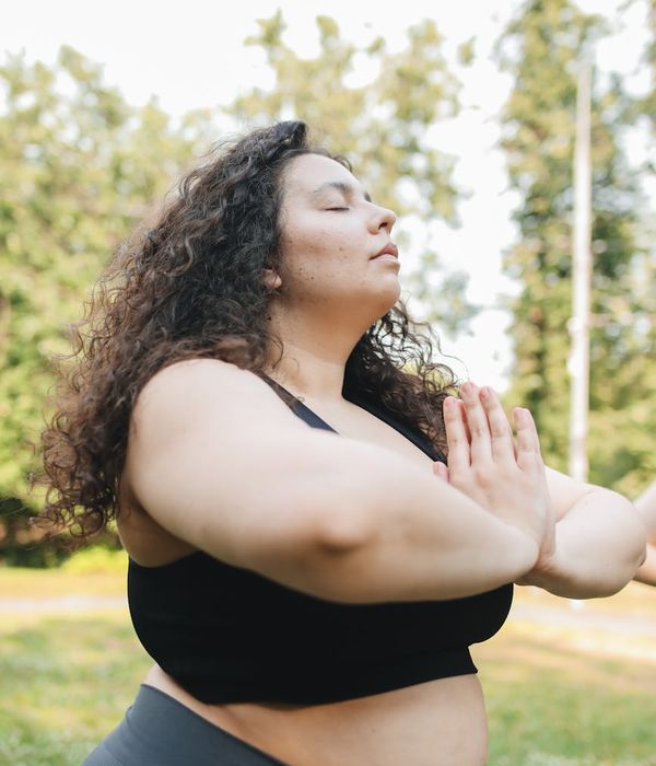A serene woman practicing breathing exercises in a calm environment.